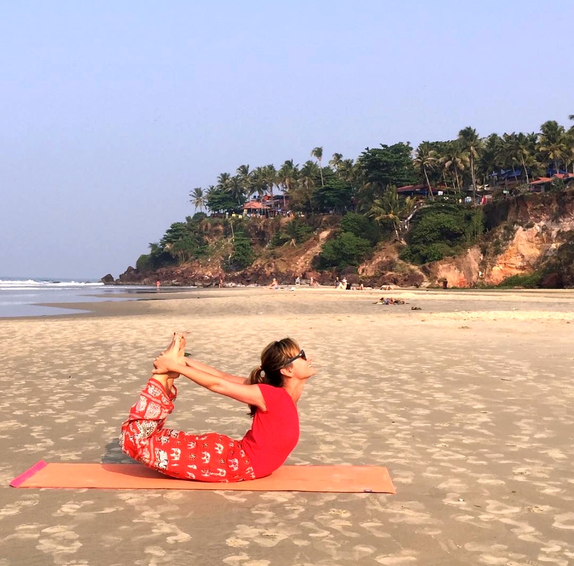 Zory in bow pose on a beach in India